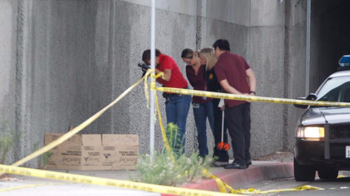 San Diego police investigators work at the scene Friday where a fifth homeless man was attacked downtown.
