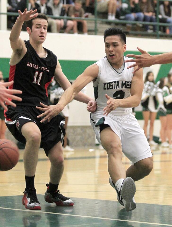 Costa Mesa High's Daniel Azurin, right, passes the ball during the first half against Harvard-Westlake in a CIF-Southern Section Division 4AA first-round game on Wednesday.