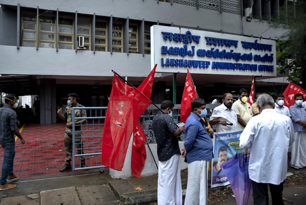 Activists carry red flags