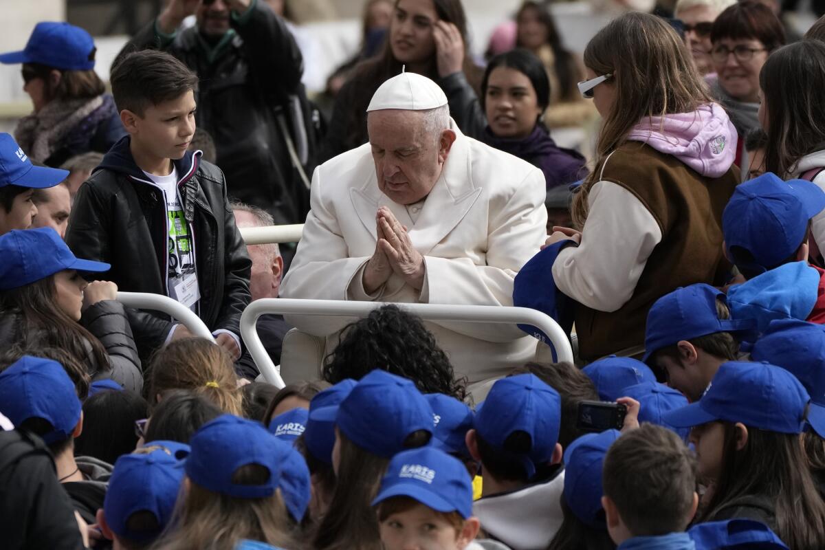 Pope Francis surrounded by children