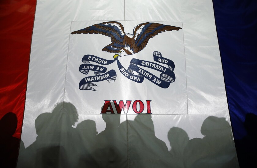 Attendees' shadows are cast on the Iowa flag at a town hall for Florida Sen. Marco Rubio in West Des Moines on Tuesday.
