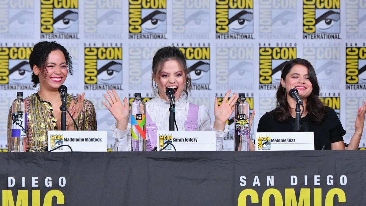 From left to right, Madeleine Mantock, Sarah Jeffery and Melonie Diaz speak onstage during the "Charmed" screening and panel at Comic-Con International 2018 in San Diego, California.