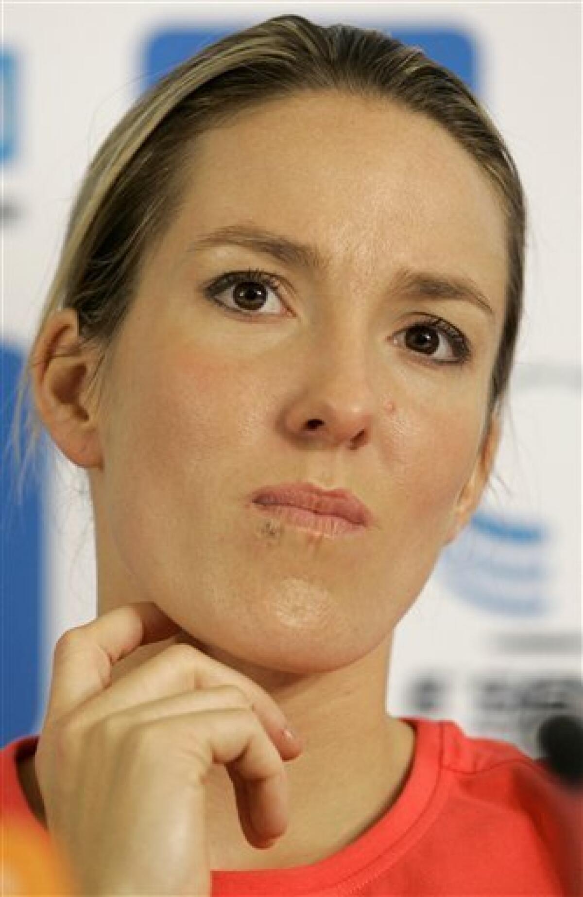 Belgium's Justine Henin, seen at a media conference, in Limelette, Belgium, Wednesday Sept. 23, 2009. Former No. 1 Justine Henin has announced her return to competitive tennis for next year. Henin had been retired for just over a year, but at 27 she says has the fire and physical strength to compete for an eighth Grand Slam title. (AP Photo/Yves Logghe)