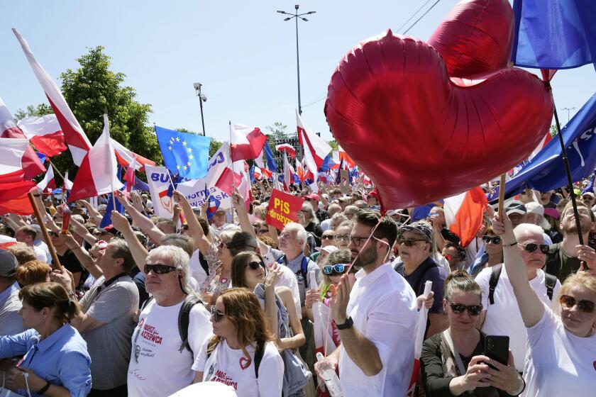 Participants join an anti-government march led by the centrist opposition party leader Donald Tusk, who along with other critics accuses the government of eroding democracy, in Warsaw, Poland, Sunday, June 4, 2023. Poland's largest opposition party led a march Sunday meant to mobilize voters against the right-wing government, which it accuses of eroding democracy and following Hungary and Turkey down the path to autocracy. The march is being held on the 34th anniversary of the first partly free elections, a democratic breakthrough in the toppling of communism across Eastern Europe. (AP Photo/Czarek Sokolowski)