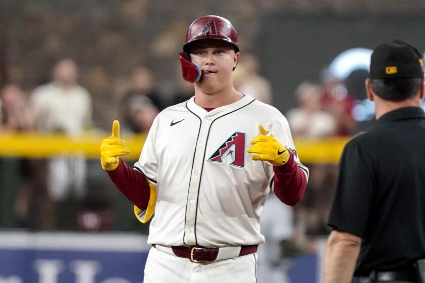 Arizona Diamondbacks' Joc Pederson gestures toward his dugout after hitting a double against the Detroit Tigers during the first inning of a baseball game Sunday, May 19, 2024, in Phoenix. (AP Photo/Darryl Webb)