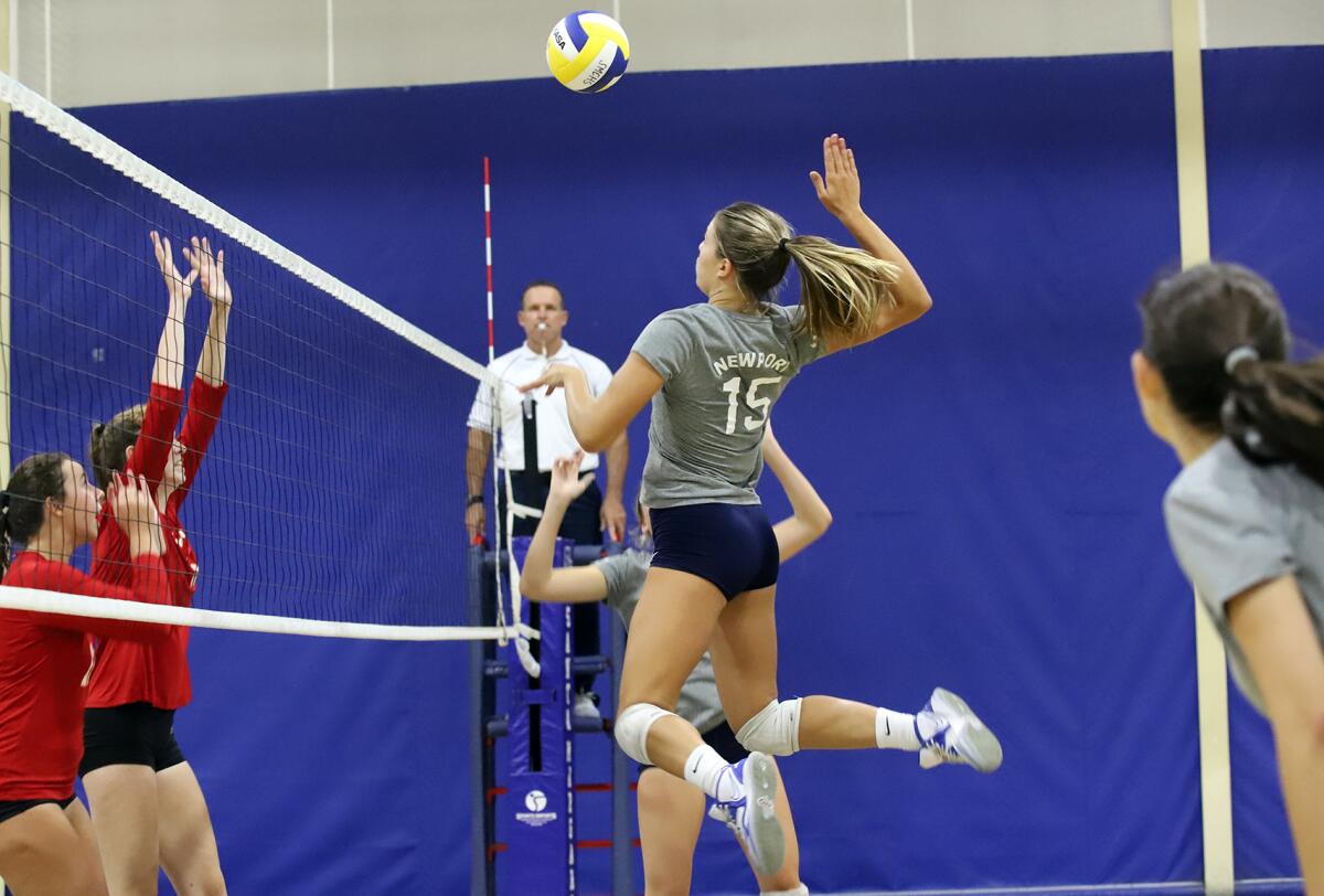 Newport Harbor's Malia Thorne (15) spikes the ball against Orange Lutheran in the Trinity-Sunset League Showcase.