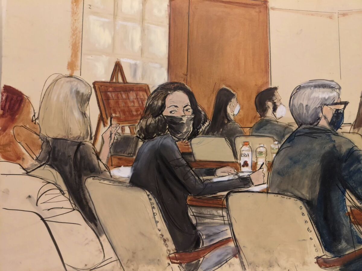 In this courtroom sketch, Ghislaine Maxwell looks over her shoulder to the courtroom audience prior to the start of jury selection in her trial, Tuesday, Nov. 16, 2021, in New York. Prospective jurors got their first glimpse of Maxwell, the British socialite charged with helping Jeffrey Epstein sexually abuse girls and women, when a judge began questioning them individually Tuesday. (AP Photo/Elizabeth Williams)