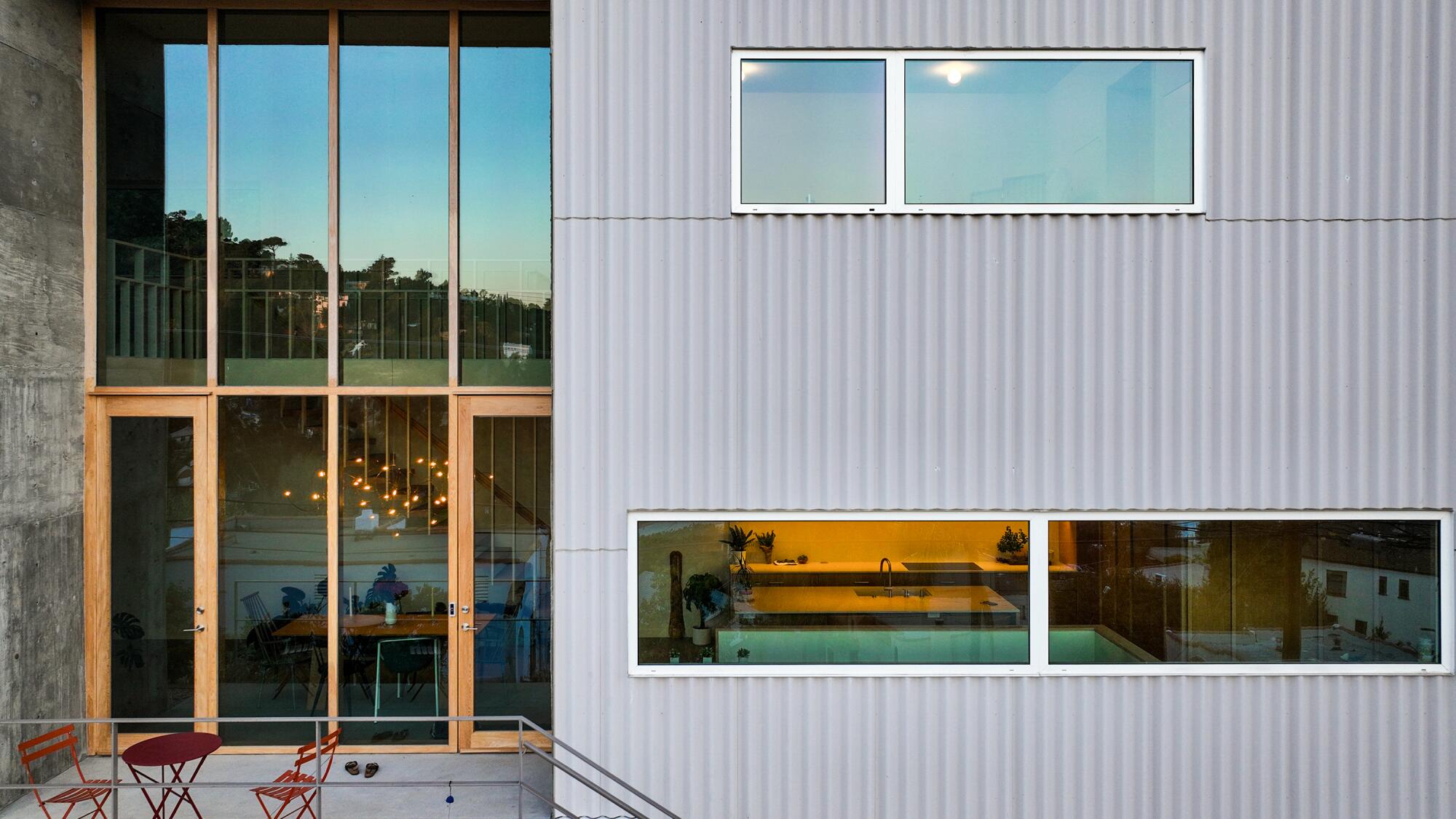 Tall and long windows across the face of the home. 