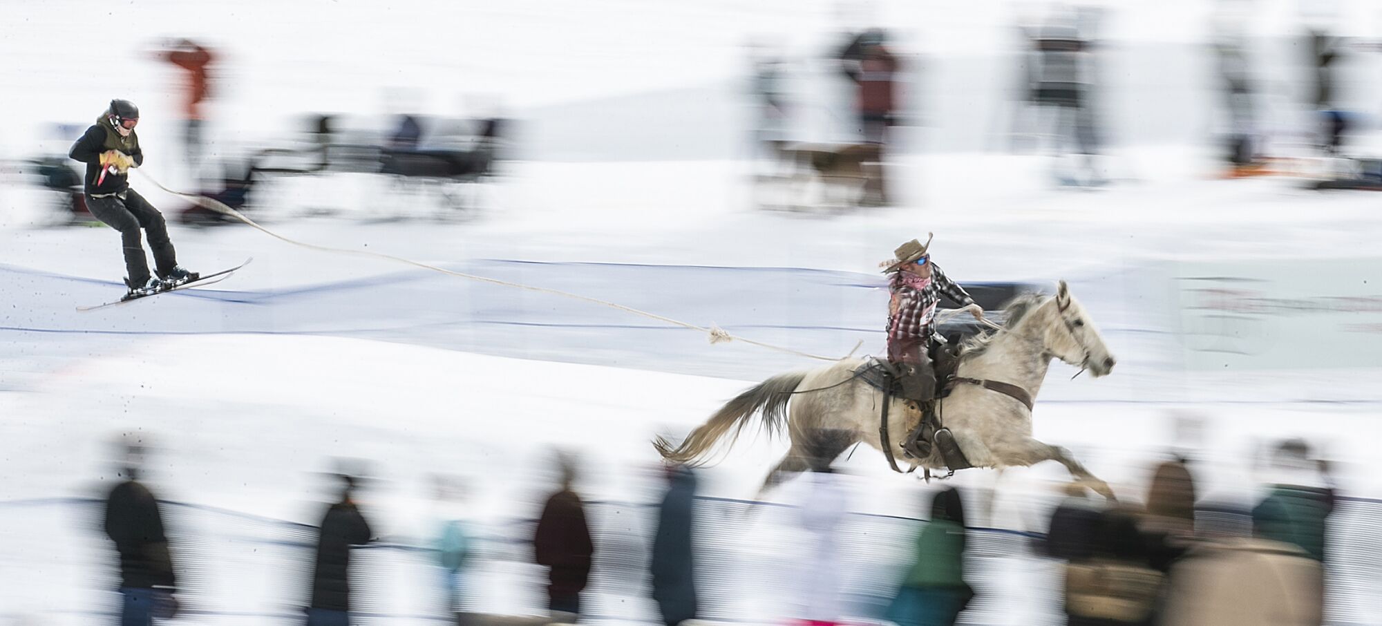 Team Cruisin' for a Bruisin' skier Jennie Hoover is pulled by Scott Hoover on Gordy at Skijoring Utah at Soldier Hollow Nordic Center.