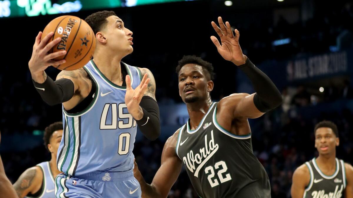 The U.S. team's Kyle Kuzma of the Lakers makes a move against the World team's Deandre Ayton of the Phoenix Suns during the Rising Stars game on Friday in Charlotte, N.C.