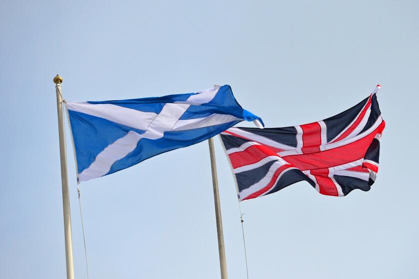 The Saltire, the national flag of Scotland, and the British Union Jack are raised above Horseguards in central London on Sept. 17, 2014, ahead of the referendum on Scotland's independence.