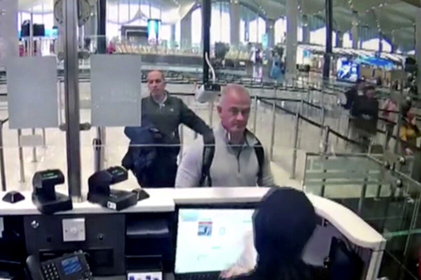 FILE - This Dec. 30, 2019 image from security camera video shows Michael L. Taylor, center, and George-Antoine Zayek at passport control at Istanbul Airport in Turkey. The trial in Tokyo of two Americans, Taylor and his son Peter Taylor, charged with helping Nissan’s former chairman, Carlos Ghosn, flee Japan wrapped up Friday, July 2, 2021 with prosecutors seeking prison terms of more than two years for each of them. (DHA via AP, File)