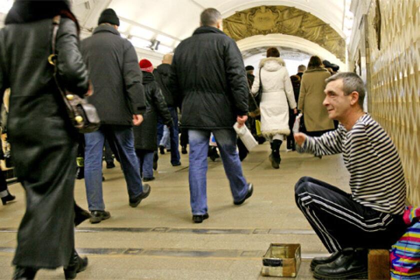 A disabled man begs in the Moscow Metro. When you take that escalator down and look at those faces, get hit with all of that anxiety, all of the worry, its incredible, one Russian says of the subway.