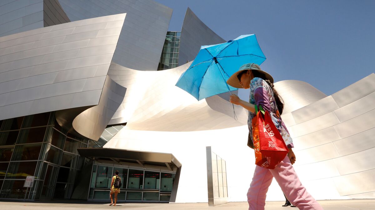A woman shields herself from the sun in downtown Los Angeles.
