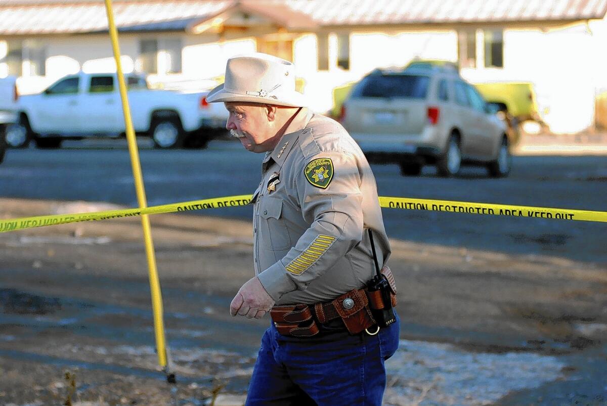 Modoc County Sheriff and Coroner Mike Poindexter surveys the scene Friday at the Cedarville Rancheria headquarters in Alturas, Calif. The day before, four people were shot and killed during a tribal meeting at the headquarters.