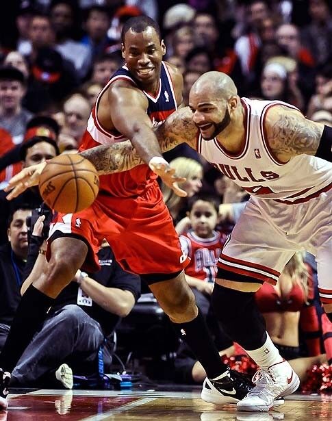 Washington Wizards center Jason Collins battles for a loose ball with Chicago Bulls forward Carlos Boozer in the final regular-season game for both teams. The Wizards did not make the NBA playoffs.