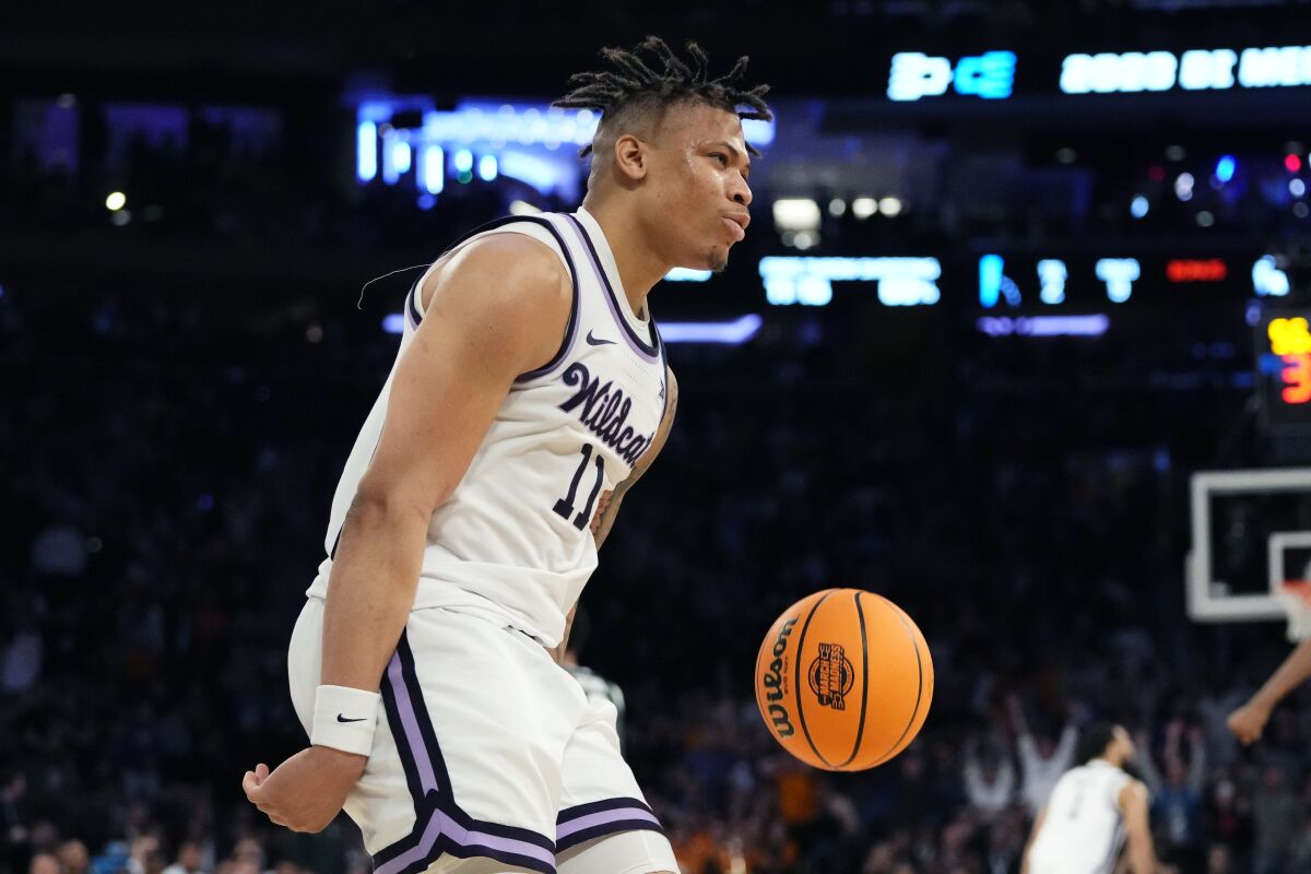 Kansas State forward Keyontae Johnson reacts after a dunk in overtime of a Sweet 16 college basketball game against Michigan State in the East Regional of the NCAA tournament at Madison Square Garden, Thursday, March 23, 2023, in New York. (AP Photo/Frank Franklin II)
