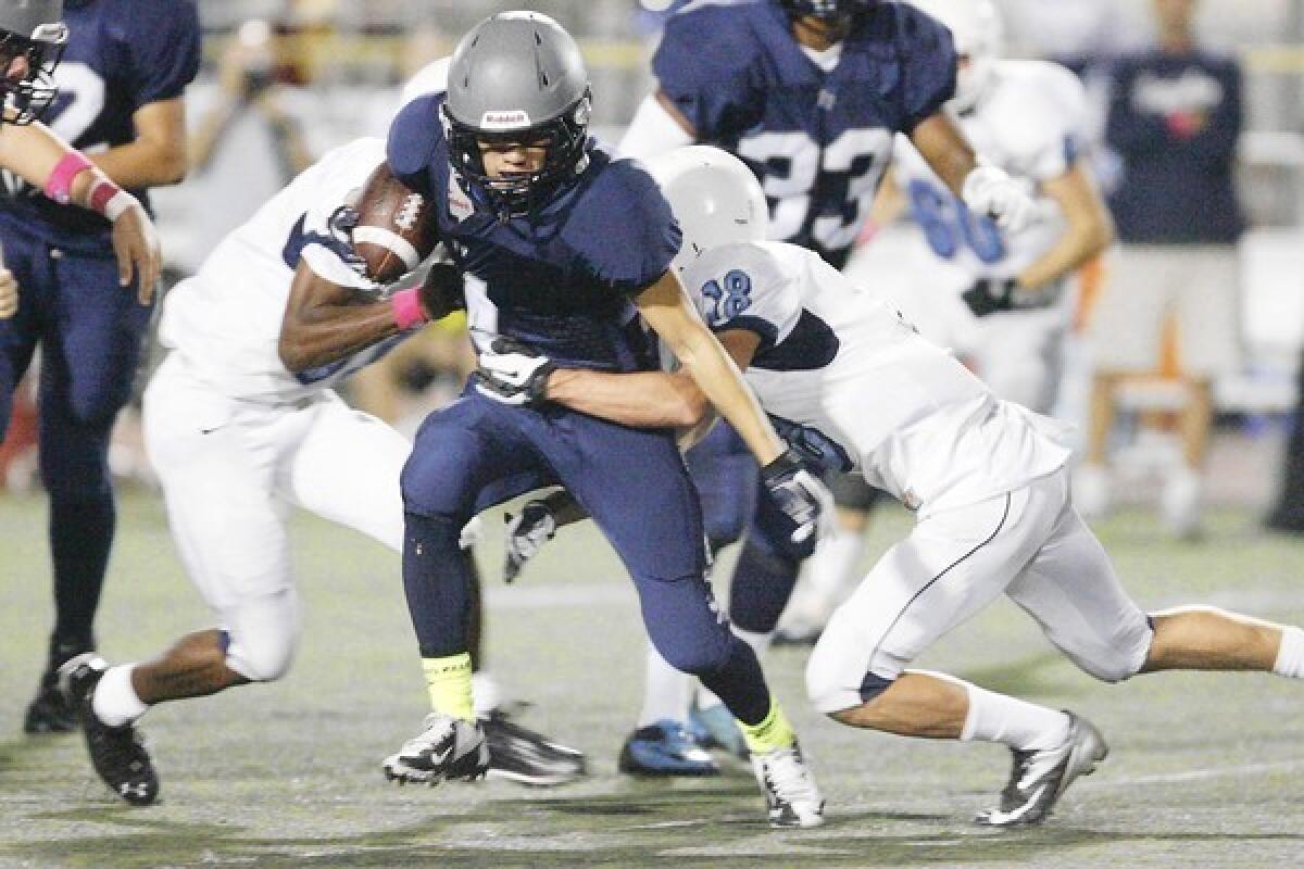 Flintridge Prep's Kyle Hamane, center, pushes ahead for more yards in a win over Chadwick.