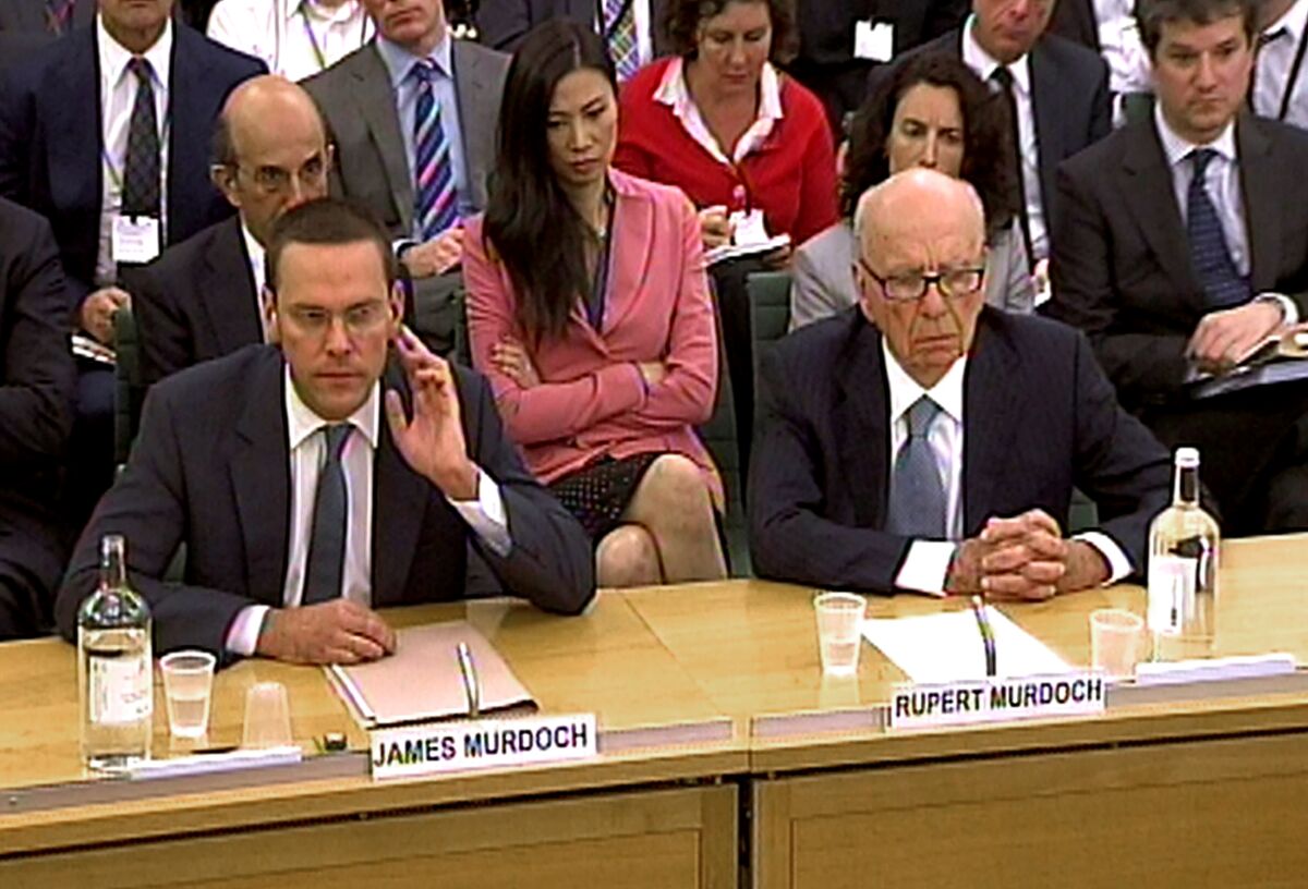 James Murdoch, left, and Rupert Murdoch appear at a hearing in the House of Commons in 2011.