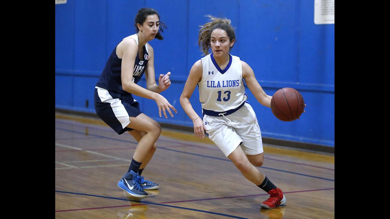 Lycee International of Los Angeles girls basketball player #13 Alexa Infante dribbles to thje basket in home game vs. Le Lycee at Olive Recreation Center in Burbank on Wednesday, Dec. 6, 2017.