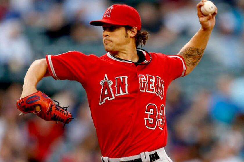 Angels starter C.J. Wilson pitches against the Seattle Mariners.