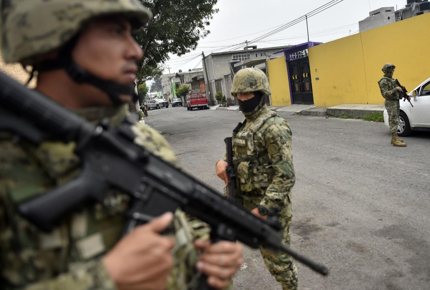 Mexican marines guard the scene of a shootout in which eight suspected drug traffickers were shot dead in Tlahuac, Mexico City on July 20, 2017.