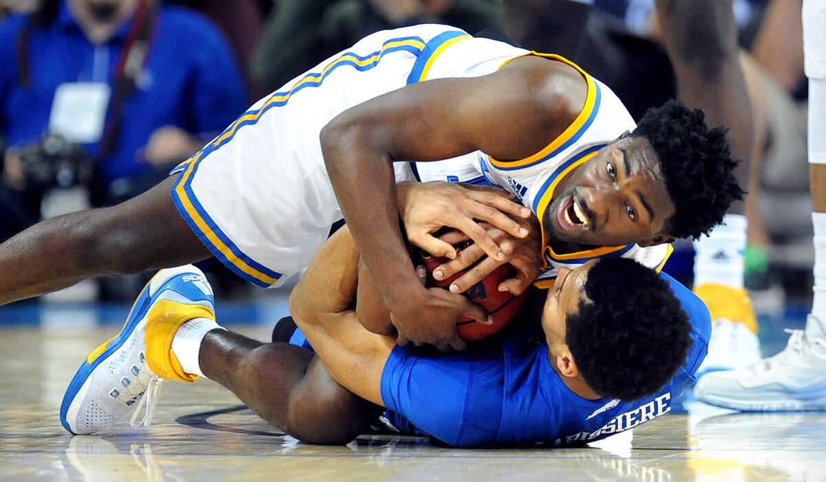 UCLA's Isaac Hamiloton battles for a loose ball with Kentuky's Skal Labissiere in the second half at Pauly Pavillion on Thursday.