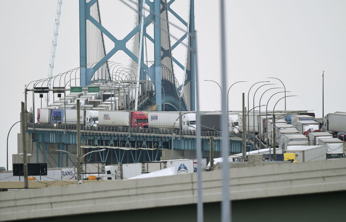 Trucks are backed up heading to and from Canada on the Ambassador Bridge in Detroit.