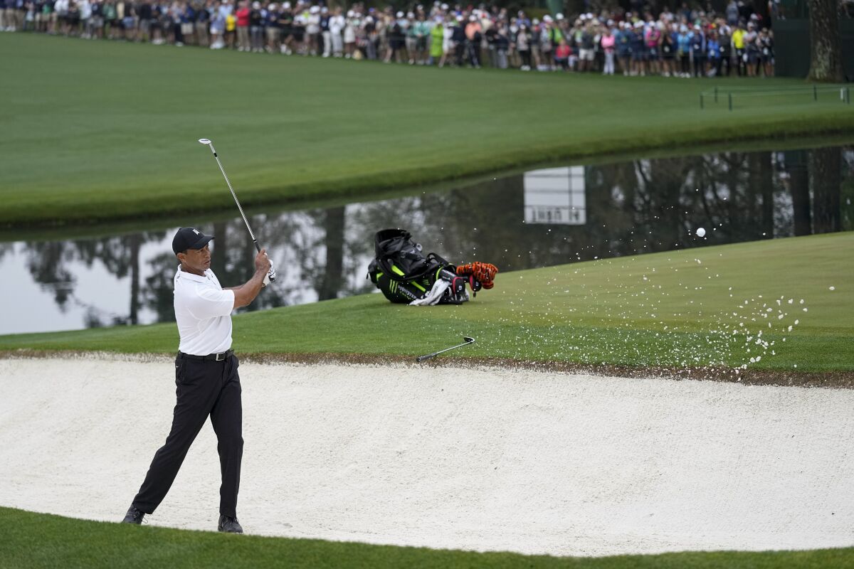 Tiger Woods hits out of a bunker on the 15th hole during a practice round for the Masters golf tournament on Wednesday, April 6, 2022, in Augusta, Ga. (AP Photo/Robert F. Bukaty)