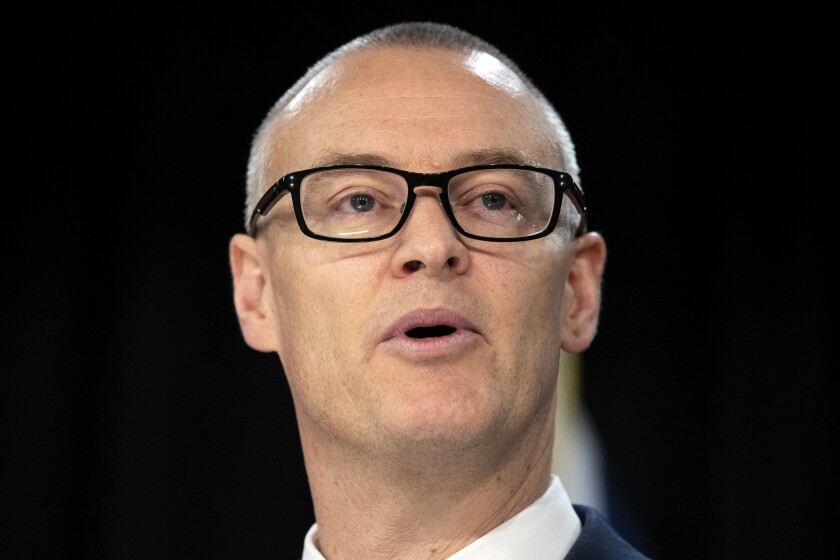 New Zealand Health Minister David Clark announces his resignation at a press conference at parliament in Wellington, New Zealand Thursday, July 2, 2020. Clark resigned Thursday following a series of personal blunders during the coronavirus pandemic. (Mark Mitchell/New Zealand Herald via AP)