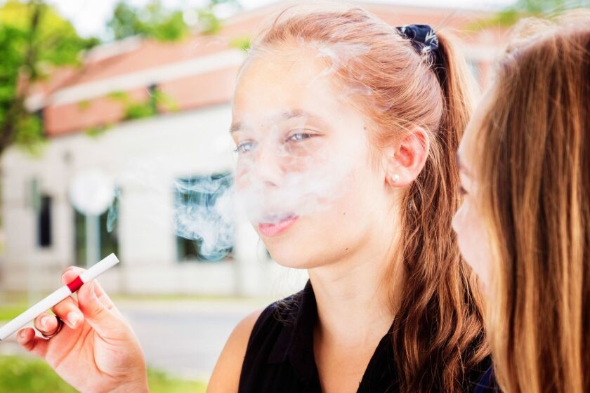 Preteen girl tries e-cigarette under the influence of her friend. User Upload Caption: Results of a recent survey found that 12- to 14-year-olds who had tried e-cigs were 2.5 times more likely to become heavy marijuana users, smoking pot at least once a week. ** OUTS - ELSENT, FPG - OUTS * NM, PH, VA if sourced by CT, LA or MoD **
