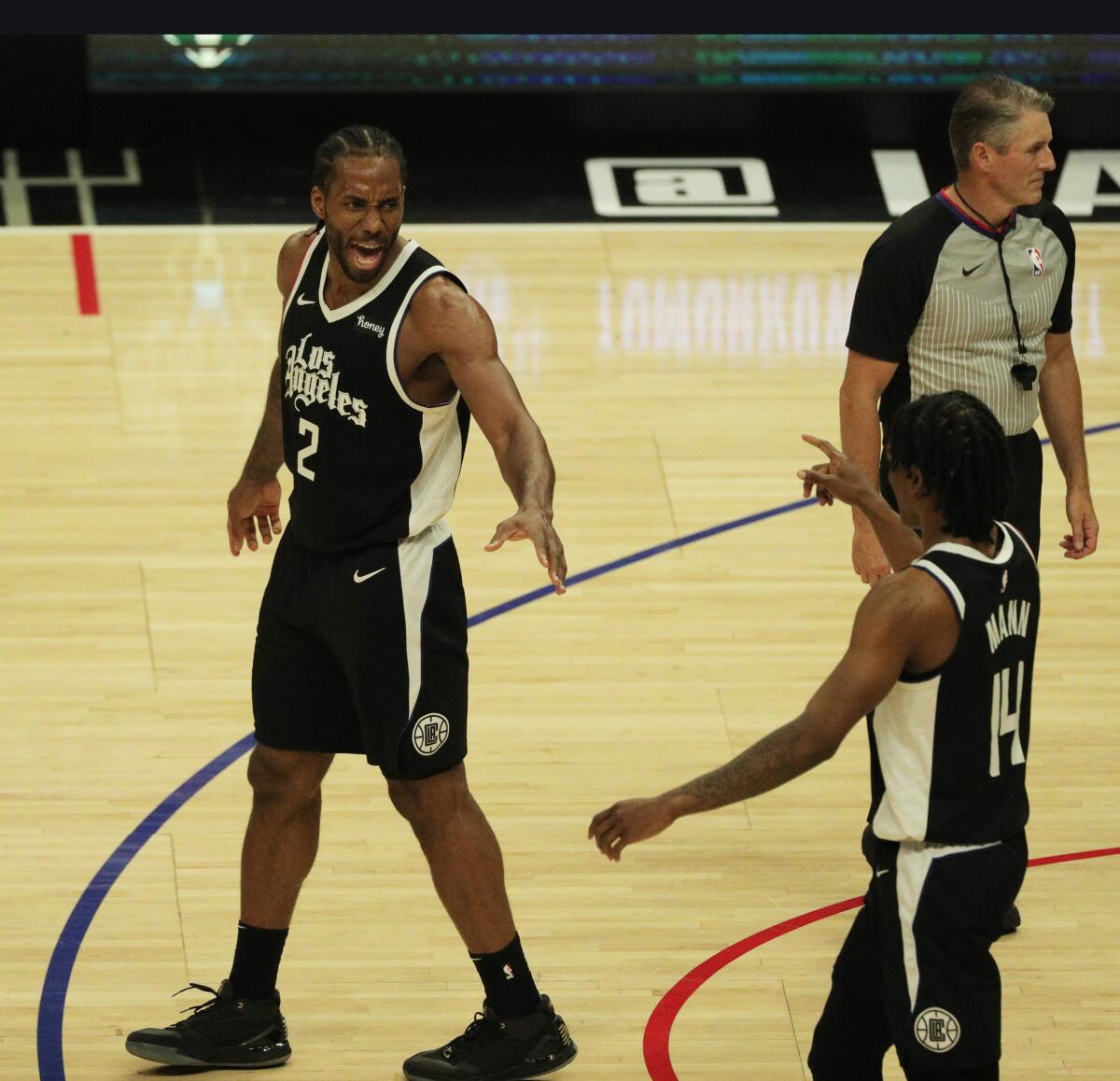 Clippers forward Kawhi Leonard, left, and guard Terance Mann celebrate during a 126-111 win over the Dallas Mavericks.