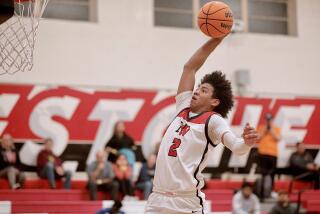 Robert Hinton of Harvard-Westlake rises up for a dunk against Palisades.