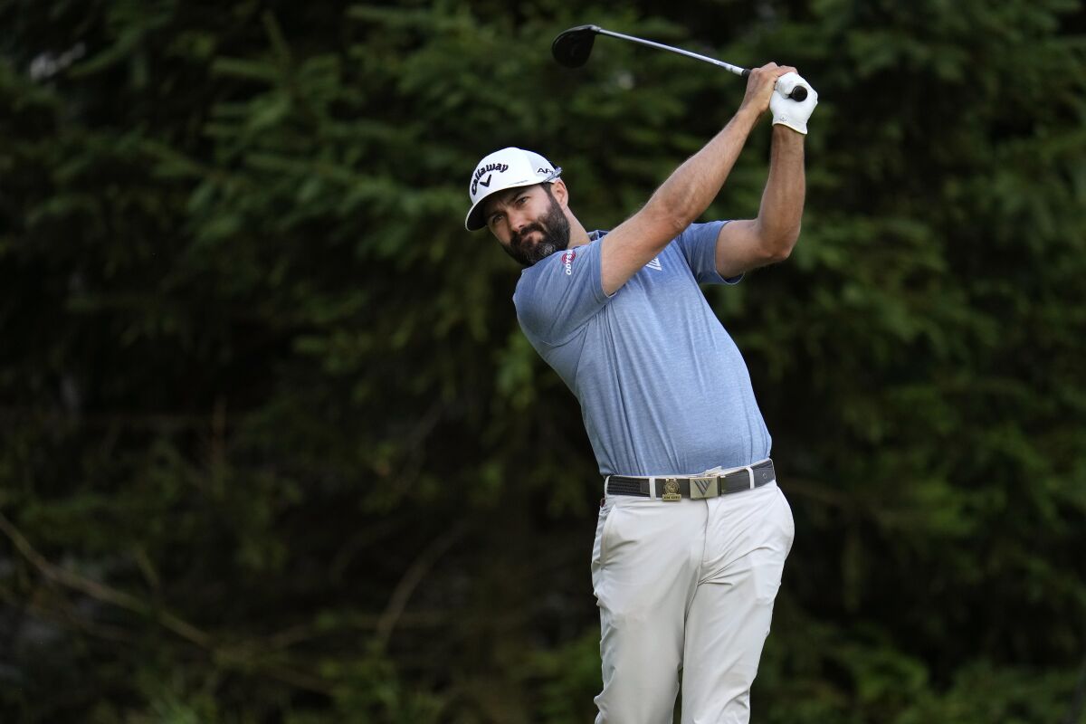 Adam Hadwin watches his shot on the 18th hole during the first round of the U.S. Open.