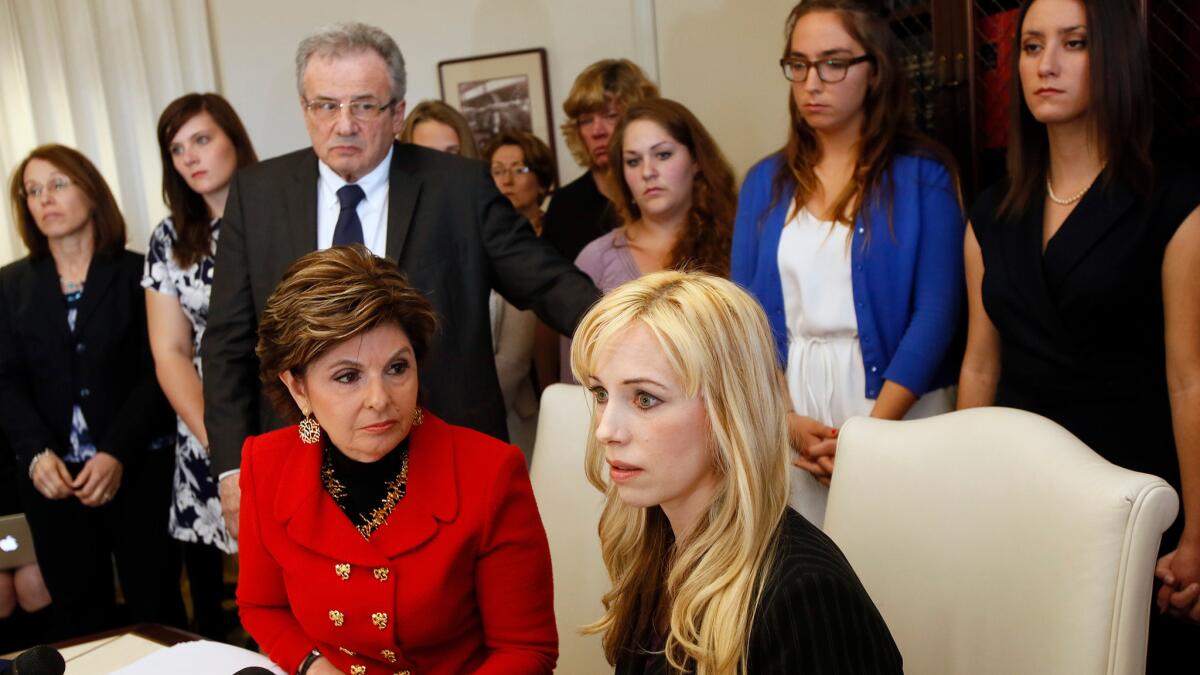Attorney Gloria Allred, left, and Caroline Heldman, professor of politics, along with 6 sexual assault victims at a news conference to announce a complaint against Occidental.