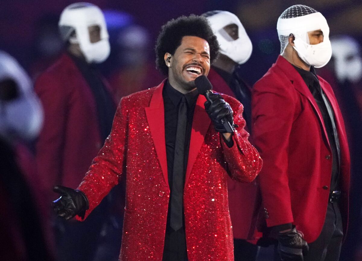 FILE - The Weeknd performs during the halftime show of the NFL Super Bowl 55 football game between the Kansas City Chiefs and Tampa Bay Buccaneers, on Feb. 7, 2021, in Tampa, Fla. The Weeknd, along with Swedish House Mafia, will replace rapper Ye, who changed his name from Kanye West, in a headlining spot at Coachella Valley Music and Arts Festival. (AP Photo/Ashley Landis, File)