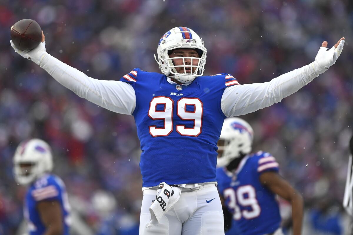 FILE -Buffalo Bills defensive tackle Harrison Phillips celebrates after recovering a fumble during the first half of an NFL football game against the Atlanta Falcons in Orchard Park, N.Y., Sunday, Jan. 2, 2022. The Minnesota Vikings began to pick away at their offseason to-do list as free agency formally opened. They agreed to contract terms with former Buffalo defensive tackle Harrison Phillips, who spent the last four seasons with the Bills, Wednesday, March 16, 2022. (AP Photo/Adrian Kraus, File)