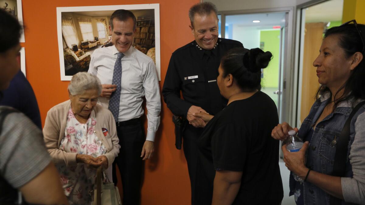 Mayor Garcetti and LAPD chief-select Michel Moore greet people at El Centro del Pueblo in Echo Park,