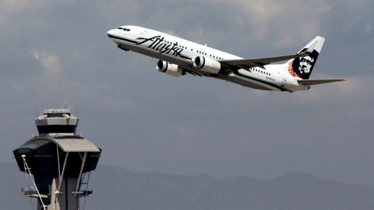 An Alaska Airlines jet takes off from Los Angeles International Airport in 2014. A Newport Beach man has agreed to plead guilty to piloting an Alaska Airlines plane while under the influence of alcohol in June that year.