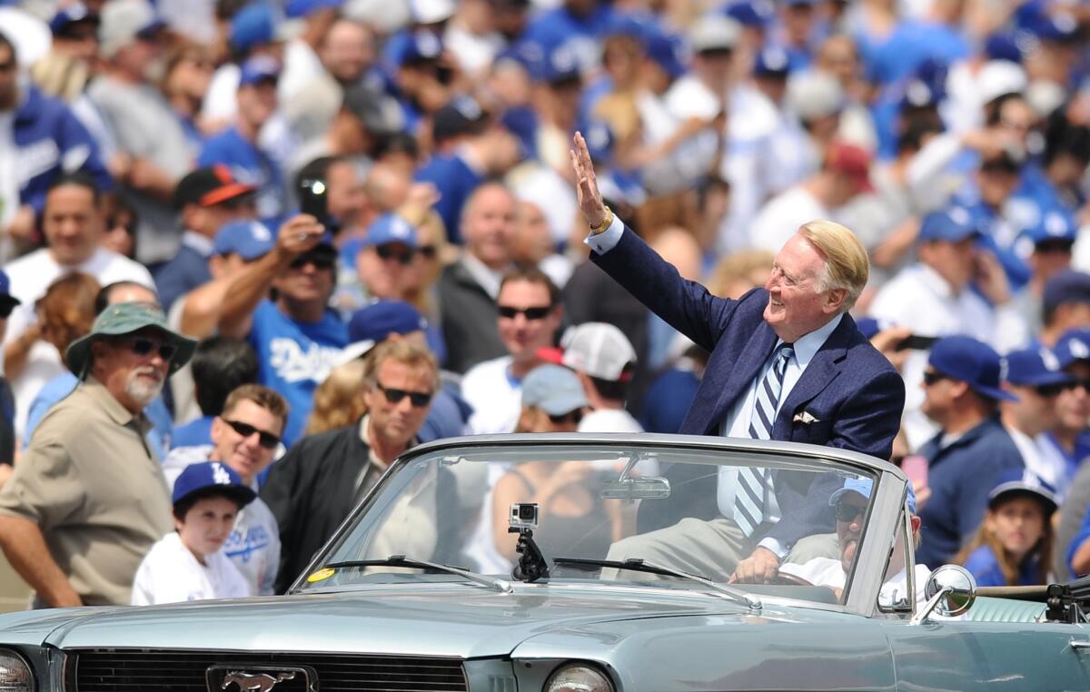 Dodgers broadcaster Vin Scully returned to the booth Wednesday after missing two games because of bronchitis.