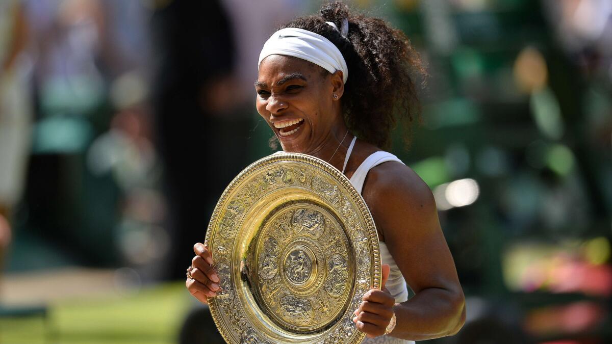Serena Williams celebrates with the winner's trophy, the Venus Rosewater Dish, after defeating Garbine Muguruza for the Wimbledon singles title on Saturday.