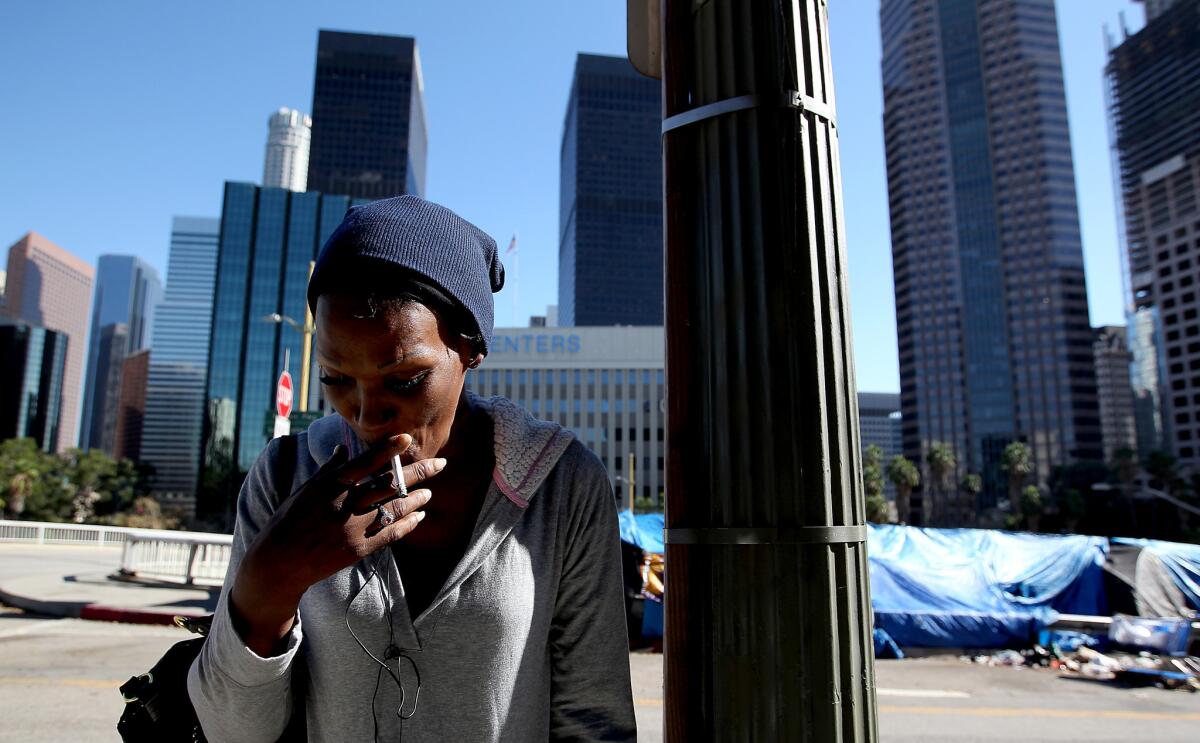 LOS ANGELES, CALIF. - OCT. 21, 2015.A homeless encampment of blue tarps and shopping carts has taken root at the intersection of Beaudry Avenue and Sixth Street, beneath the gleaming bank buildings of L.A.'s downtown financial district. (Luis Sinco/Los Angeles Times)