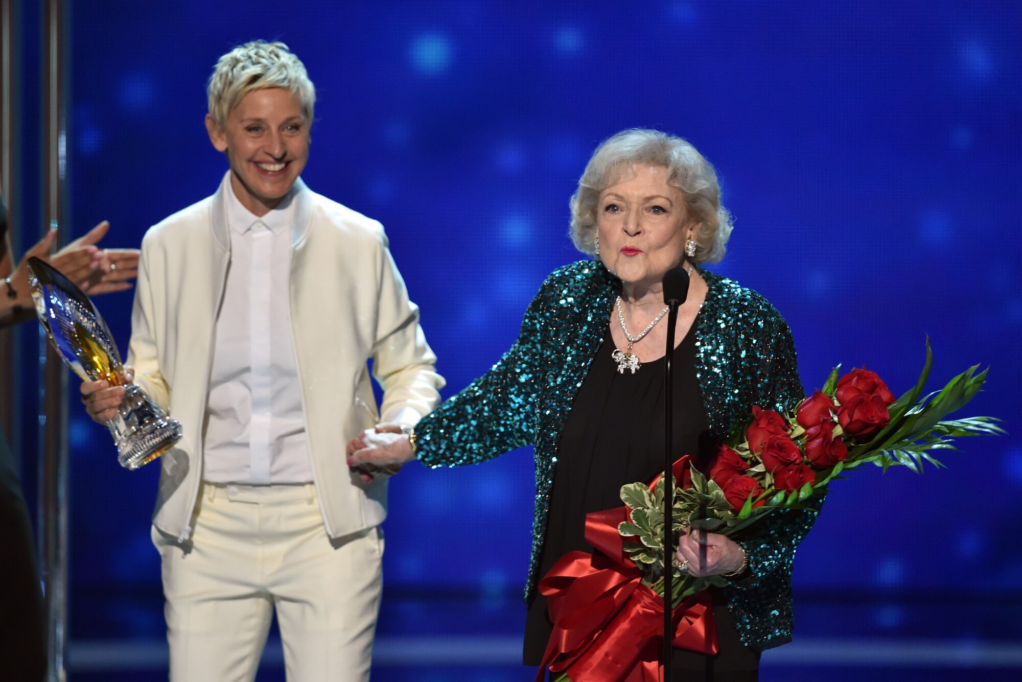 Ellen DeGeneres, left, and Betty White speak on stage at the 41st People's Choice Awards at the Nokia Theater.