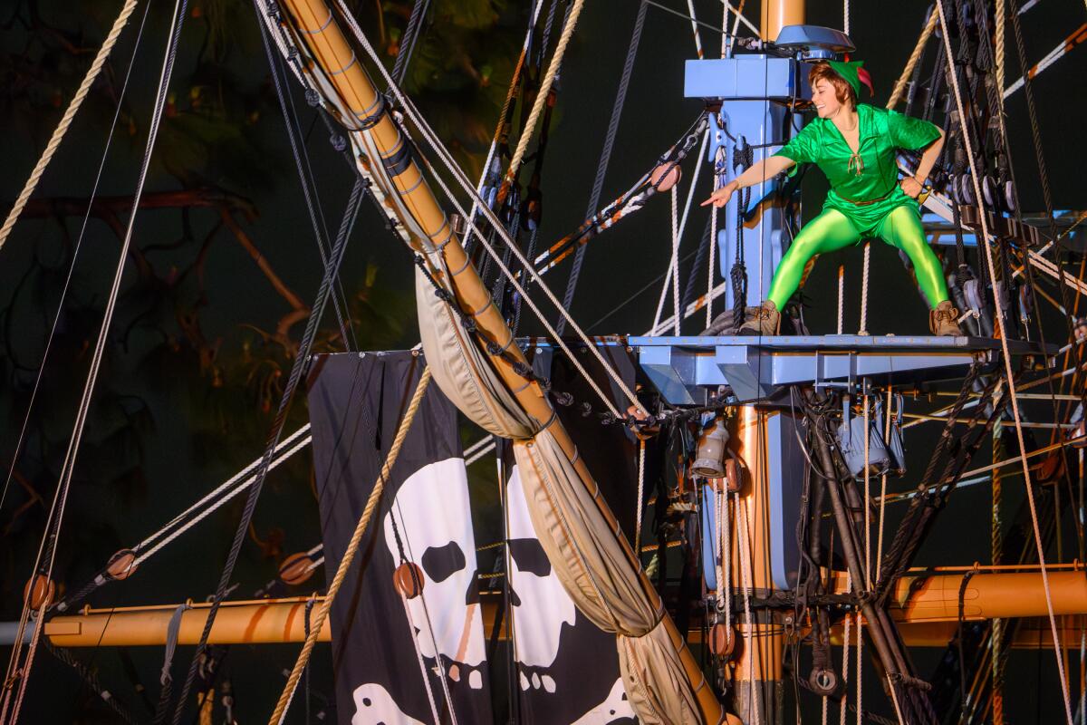 Peter Pan atop a pirate ship. 
