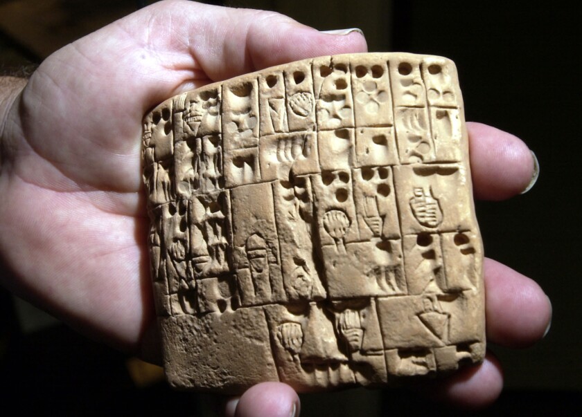 A replica of a cuneiform tablet similar to those excavated at Nineveh, now in Iraq, dating to 3100 B.C.