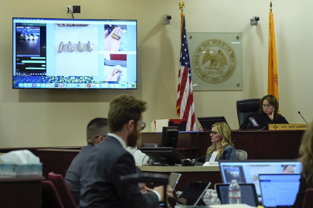 Evidence is displayed on a monitor as a judge presides over the courtroom