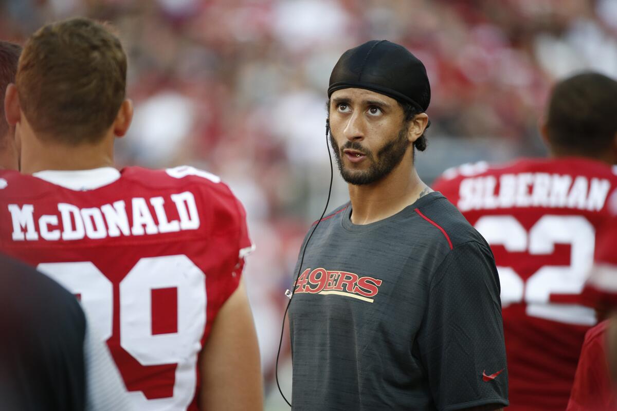 San Francisco quarterback Colin Kaepernick stands on the sidelines during the 49ers' preseason game against the Houston Texans on Aug. 14.