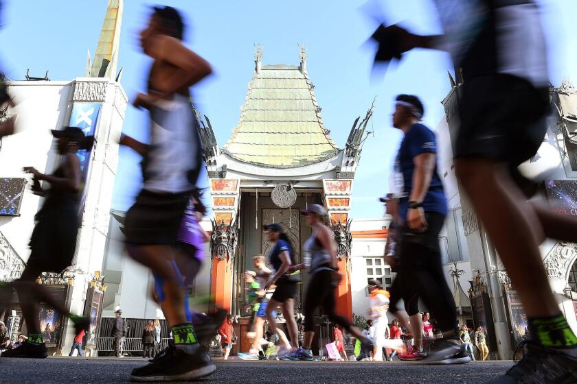 Race participants pass by Grauman's Chinese Theater during the 32nd annual Los Angeles Marathon.
