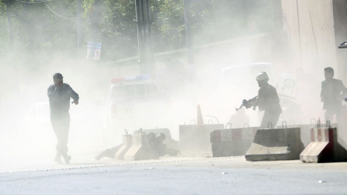 Security forces at the site of a suicide attack after the second bombing in Kabul on April 30, 2018.