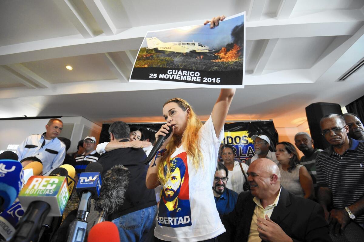 Lilian Tintori, a critic of the Venezuelan government, holds a photograph of the aircraft that she says her staff was traveling in and that may have been tampered with. She recently attended a campaign event where a local opposition official was killed.